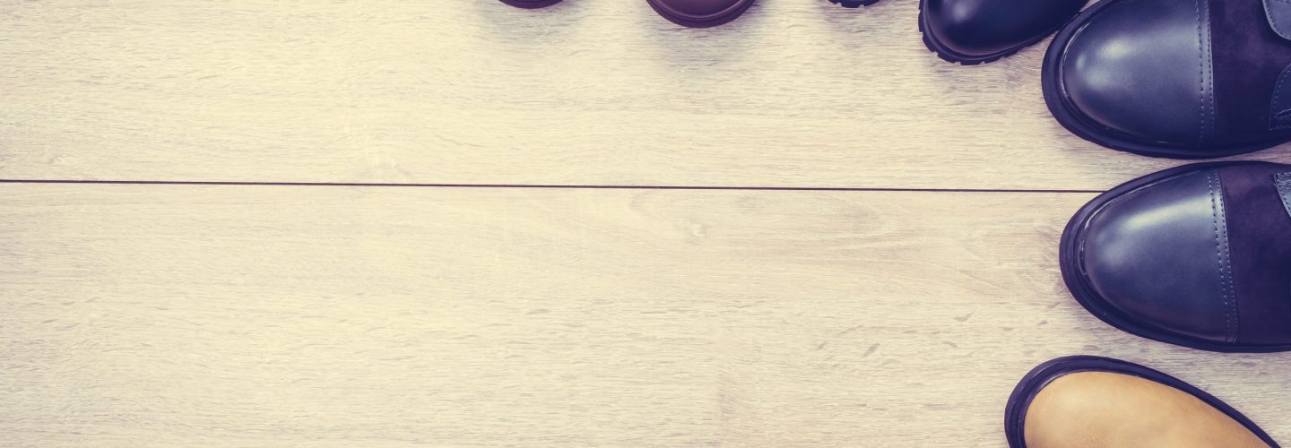 Leather boots and shoes on wooden background - Vintage Filter