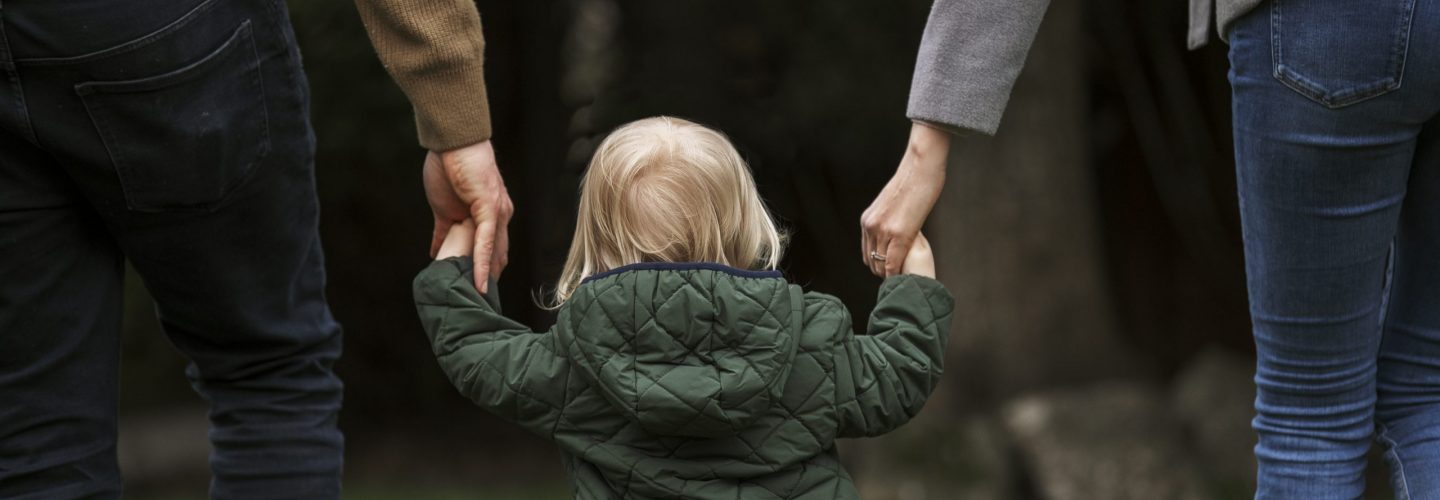 parents-walking-with-kid-park